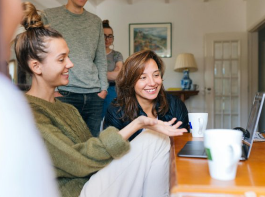 People collaborating around a laptop